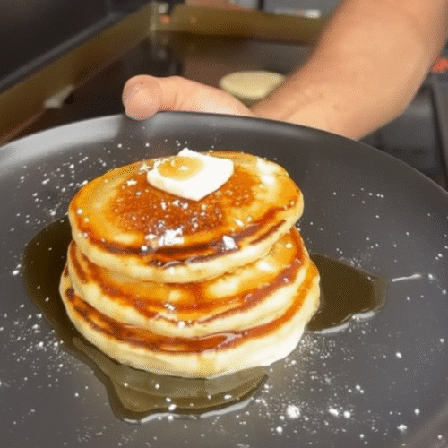 Pancakes on the griddle. 3 Pancakes on the griddle featured